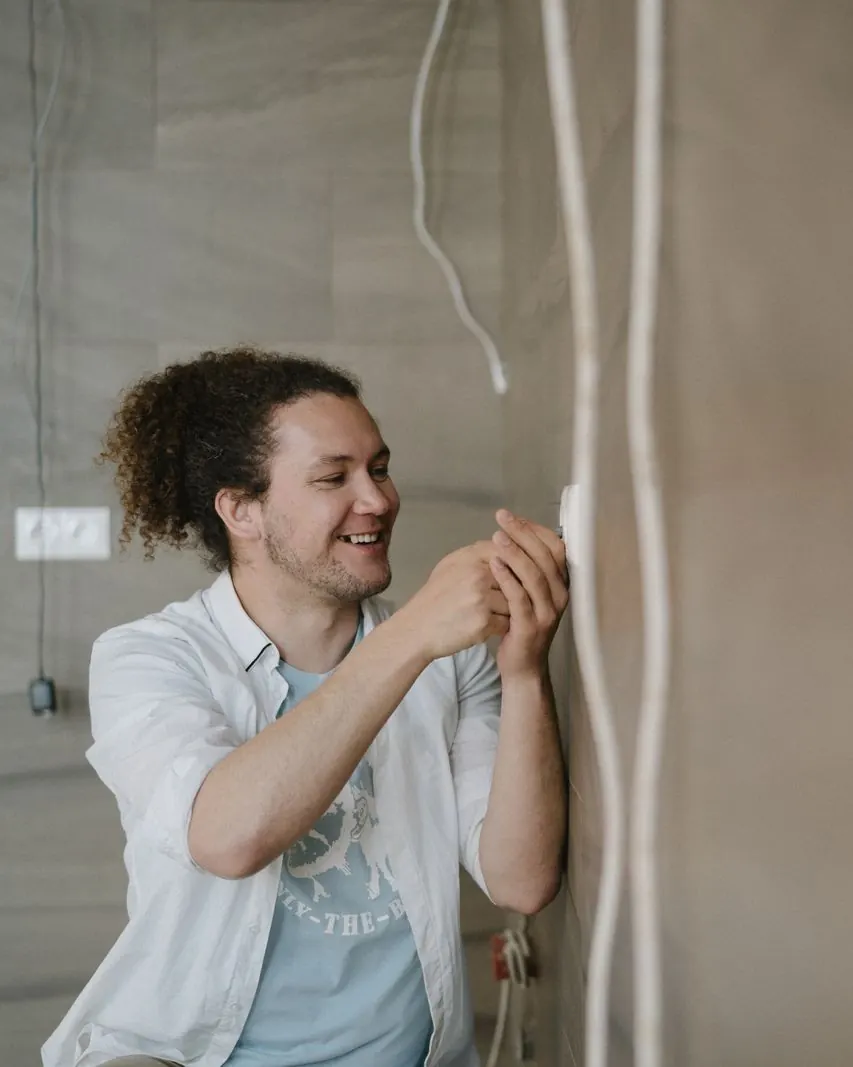Électricien souriant sur un chantier (photo d’illustration)